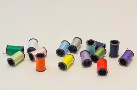 A row of spools of colored thread for the background. Stock Photos