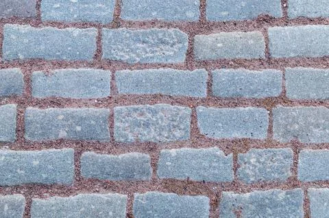 Row of stone rectangular gray tiles with terracotta brown gravel sand pattern Stock Photos