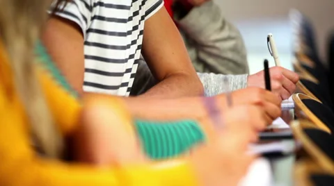 Row of students taking notes in class Stock Footage 33376336