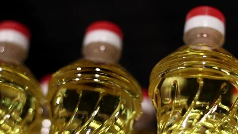 Row of Sunflower or Corn Oil Plastic Bottles at Supermarket lined Up on black Stock Footage 273755759