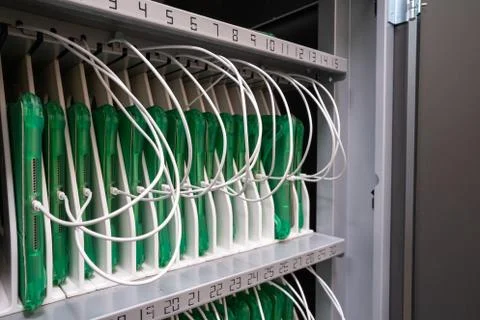 Row of tablets in protective cases being charged in a cabinet in enterprise Stock Photos