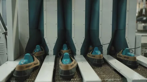 Row of Tan Shoes with Blue Toe Forms in Automated Lasting Machine Stock Footage 333016008