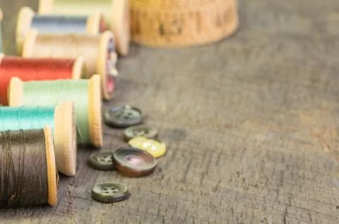 A row of thread spools with buttons Foto stock