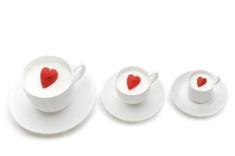 Row of three cups of different size with heartshaped berries inside them Stock Photos