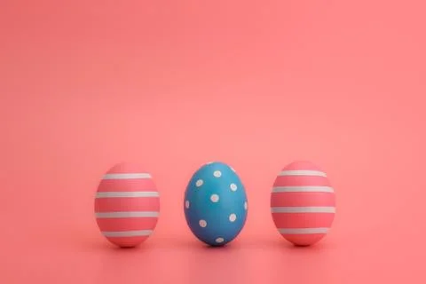 Row of three decorated Easter eggs on a pink background. Copy space Stock Photos