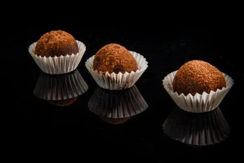 Row of three useful handmade round chocolate candies Fotos de archivo