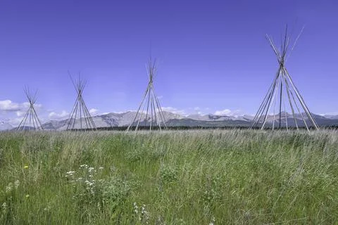A Row of Tipi Frames on the Foothills Stock Photos