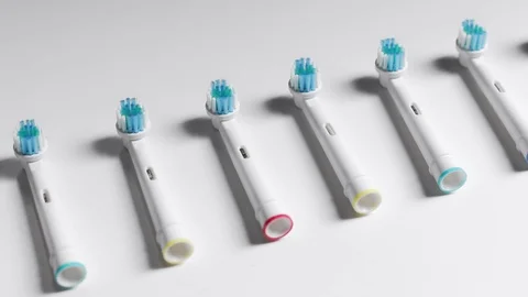 Row of toothbrush heads on a white background Stock Footage 117178444