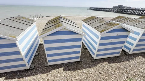 Row of traditional striped beach huts panning Stock Footage 338250658