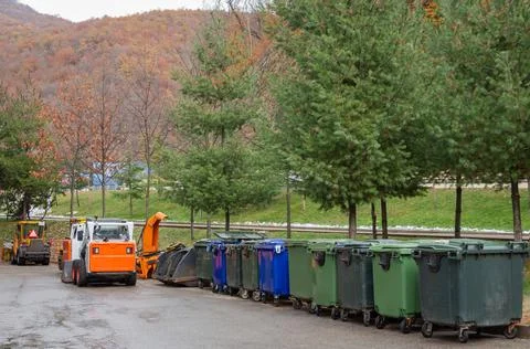 A row of trash cans. Technique for cleaning city streets. Stock Photos