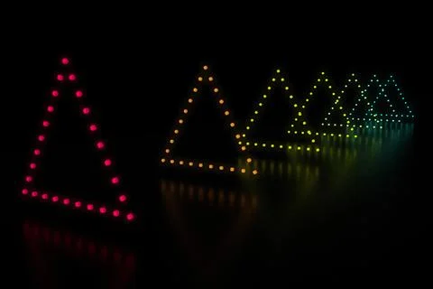 Row of triangle shaped multi colored LED lights Illustrazione stock