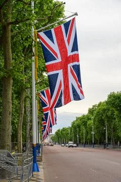 A row of Union Jack flags hanging along the Mall in London up to Buckingham P Stock Photos