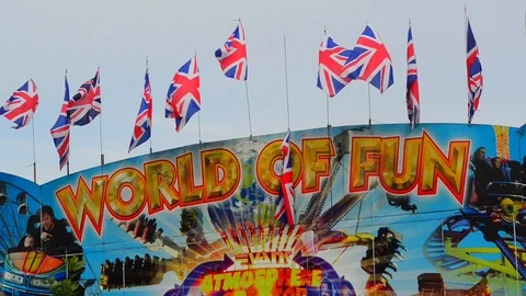 Row of union jack flags on top off ride at funfair leeds uk Stock Footage 94711061