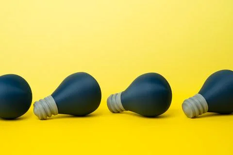 A row of unlit idea bulbs. Startup incubator. Spark inspiration. Idea generat Stock Photos