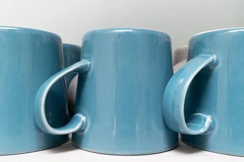 Row of Upside-Down Blue Ceramic Mugs on Kitchen Counter Stock Photos