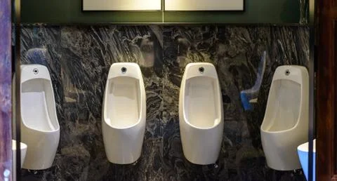 Row of urinal in Empty public men toilet Stock Photos