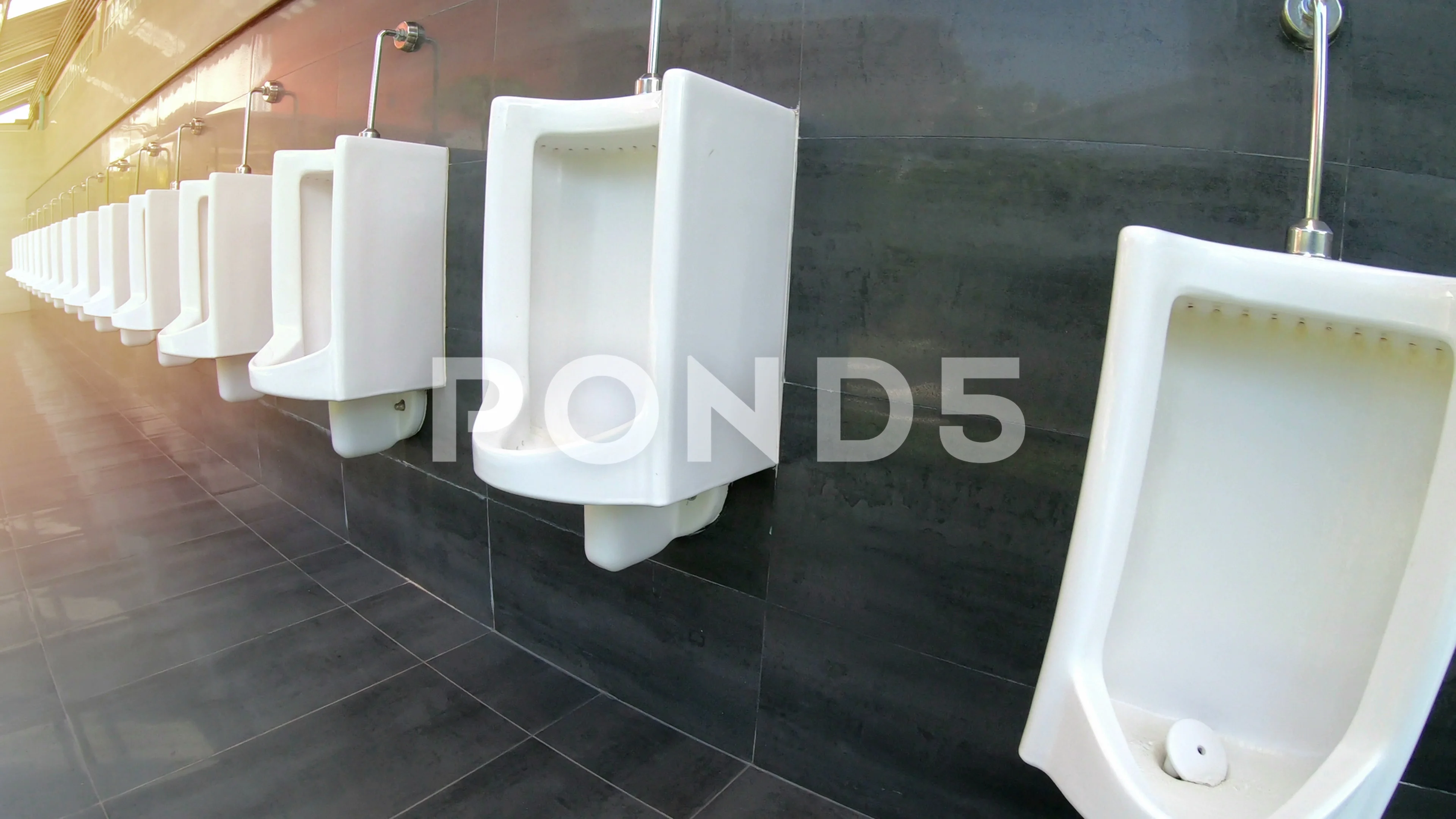 row of urinals men public toilet moving by stabilizer