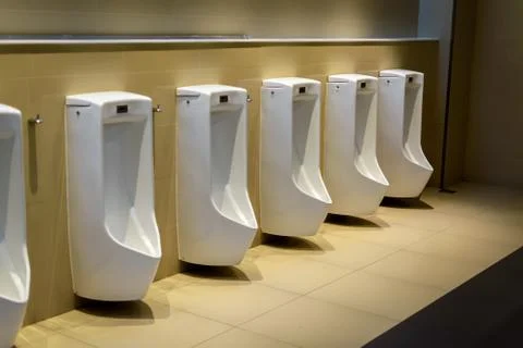 Row of urinals on the wall in W.C. Stock Photos