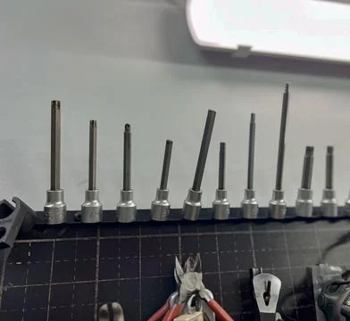 A row of various mechanic tools displayed on a workbench. Stock Photos