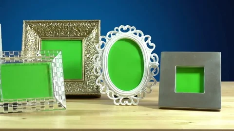 Row of various photo frames with green screen on elegant table interiors disp Stock Footage 80566705
