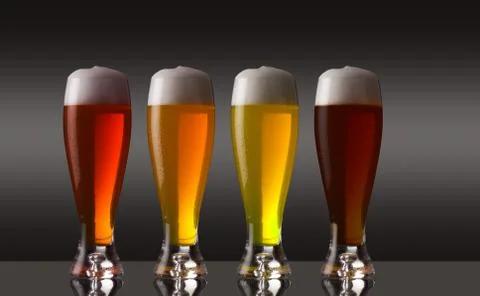Row of various types of beer with foam Foto stock