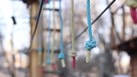 A row of vertically hanging strong ropes with securely tied knots at the ends 스톡 동영상 331501779