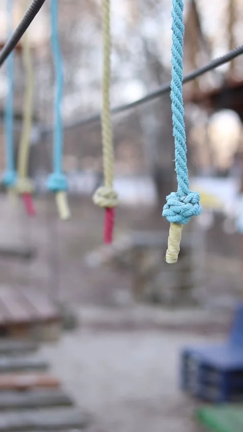 A row of vertically hanging strong ropes with securely tied knots at the ends Stock-Footage 331501796