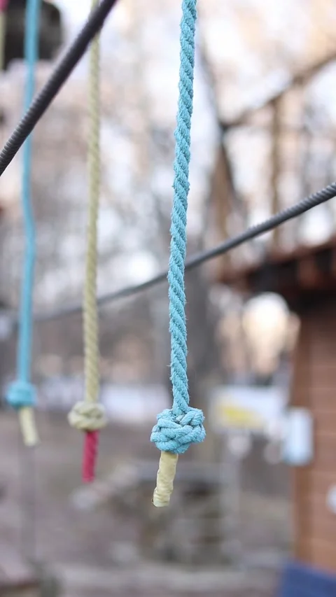 A row of vertically hanging strong ropes with securely tied knots at the ends Stock-Footage 331501810