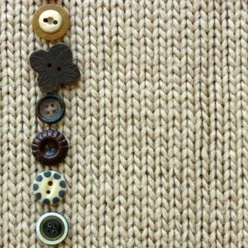Row of vintage buttons lined up on soft square fabric background Stock Photos