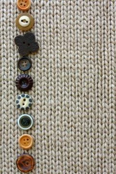 Row of vintage buttons lined up on soft fabric background Stock Photos
