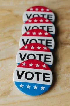 Row of vote badges on a marble surface Stock Photos