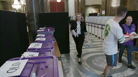 A row of voting booths and ballot boxes inside Australia House Stock Footage 345299074