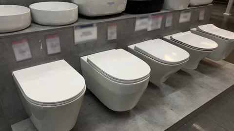 Row of Wall-Mounted Toilets on Display in Bathroom Store | Modern Sanitary Ware Stock Footage 342463747