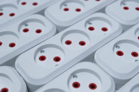 Row of white and red electrical outlets Stock Photos
