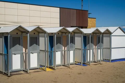 Row of white beach huts. Photos