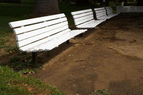 Row of white benches Stock Photos