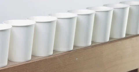 Row of white blanc paper cups goes to unfocus Stock Footage 75848754