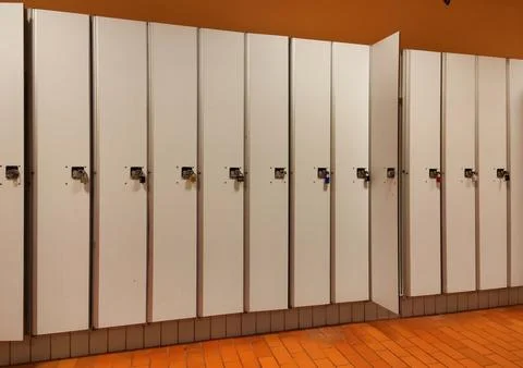 Row of white lockers with padlocks in a changing room Stock Photos