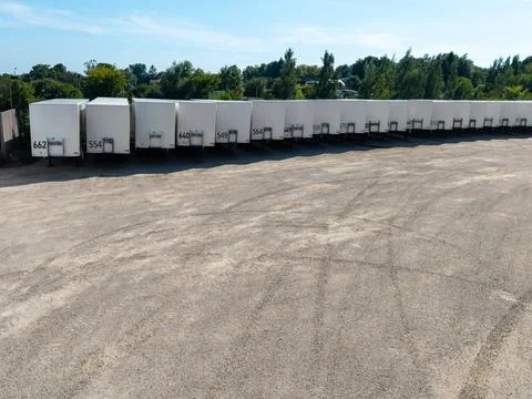 Row of White Semi Trailers Parked in Logistics Yard Stock Photos