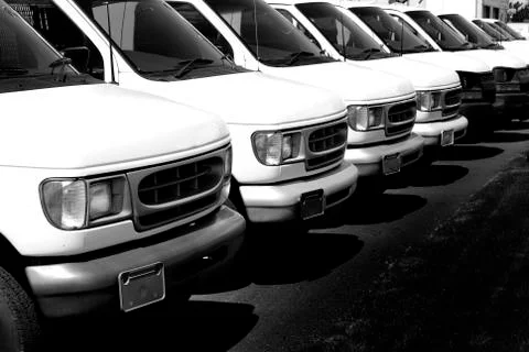 Row of White Vans Deliver Cargo Truck Transportation and Delivery Stock Photos