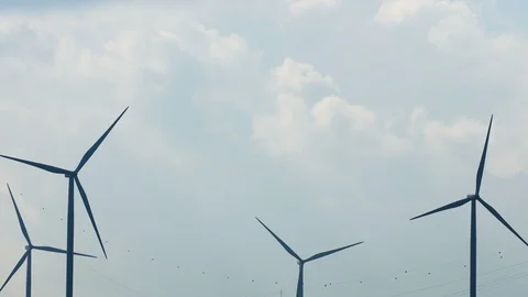 Row of wind power generators on blue background Stock Footage 103149163