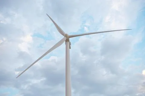 Row of wind power generators on blue sky background. Stock Photos