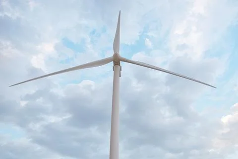 Row of wind power generators on blue sky background. Stock Photos