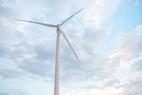 Row of wind power generators on blue sky background. Stock Photos