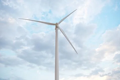 Row of wind power generators on blue sky background. Stock Photos