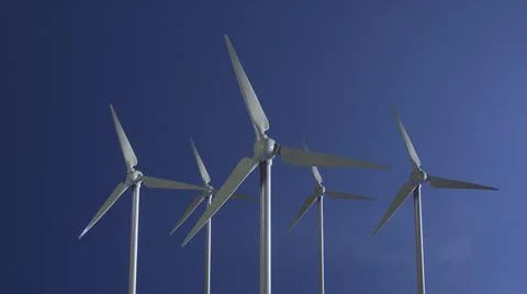 Row of wind power generators on blue sky background. 3d illustration Foto stock