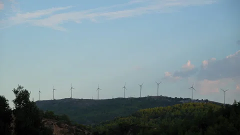 A row of wind turbines are on a hillside Stock Footage 272223375