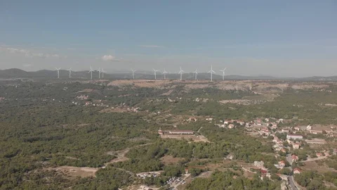 Row of wind turbines on a hill. Wind farm prodices energy. Aerial shot Stock Footage 126242655