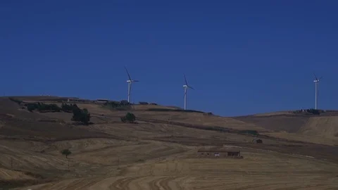 Row of wind turbines, renewable electric energy solution to climate change.  Stock Footage 125881663