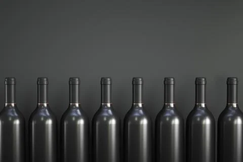 A row of wine bottles. Gray background. Copy space. Foto stock